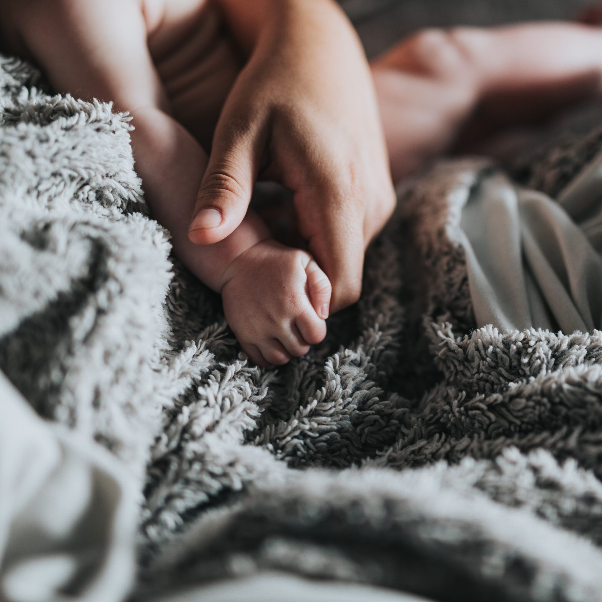 A mother resting at home with her newborn